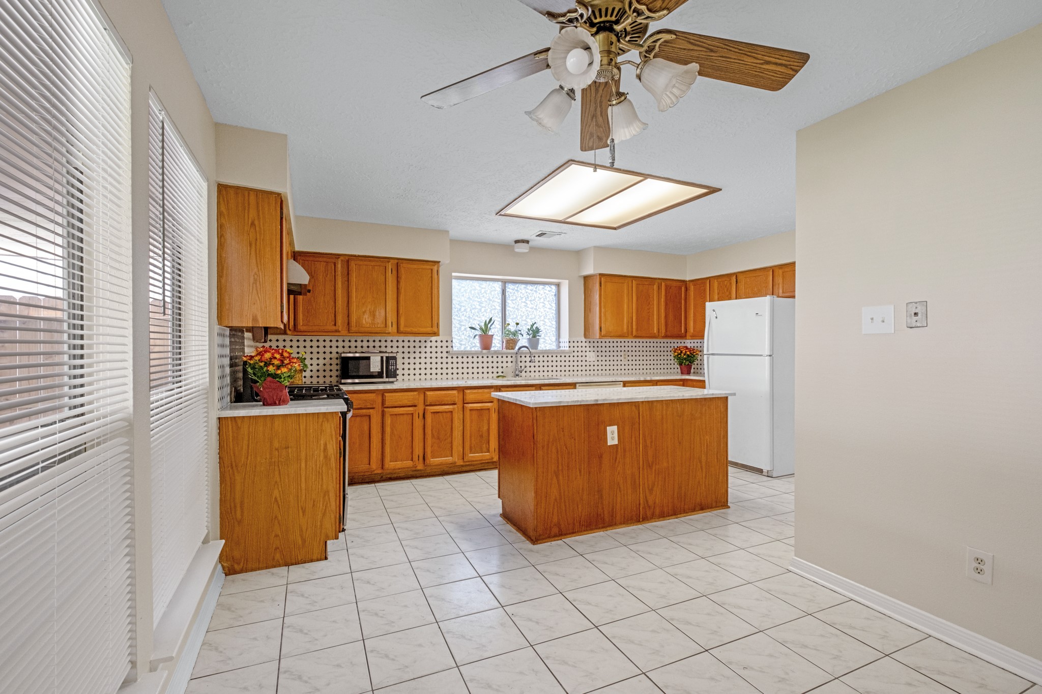 4131 Club Valley Drive Houston, TX 77082 - Photo 10 of 28 a kitchen with stainless steel appliances granite countertop a refrigerator a sink a stove top oven and cabinets