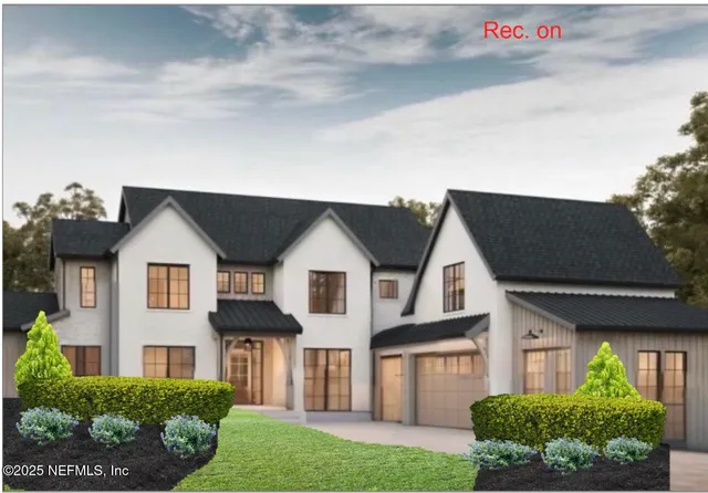 a front view of a house with a garden