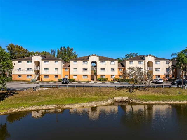 a view of swimming pool with outdoor seating and lake view
