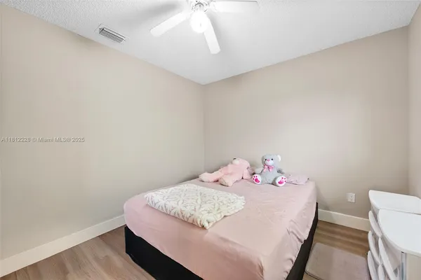 a bedroom with a bed and a dresser in it