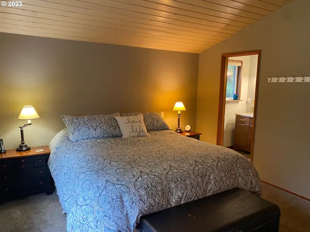 a bedroom with a bed and a lamp