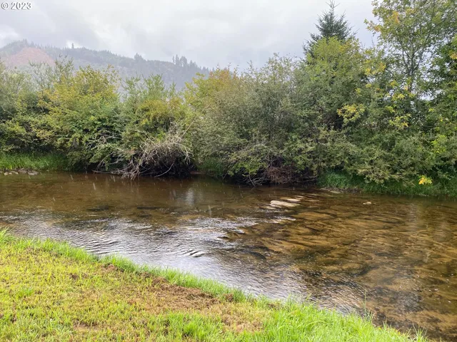 a view of a field with an ocean in the background