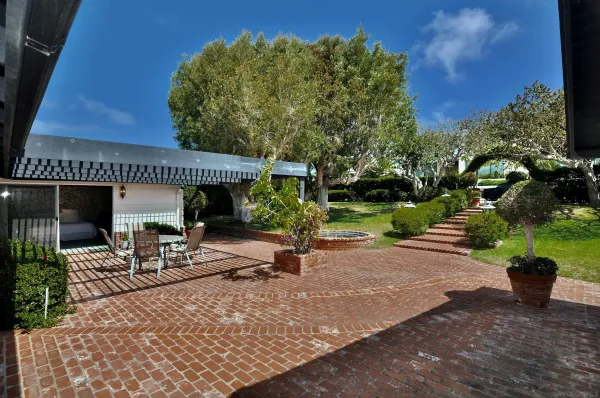 a front view of a house with a garden