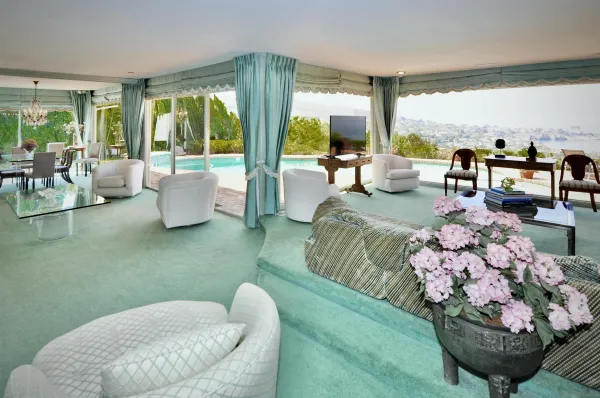 a living room with patio furniture and a large window
