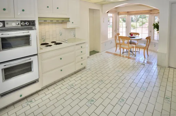 a kitchen with stainless steel appliances kitchen island granite countertop a stove a sink and a refrigerator