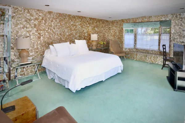 a bed sitting in a room next to a window