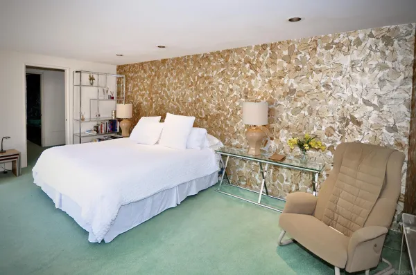 a bedroom with a bed couch and table