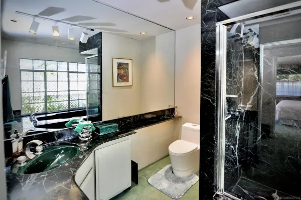 a bathroom with a sink toilet and shower