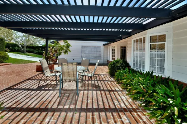 a view of a patio with table and chairs with wooden floor and fence with a garden view
