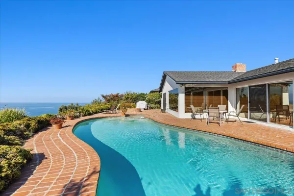 a view of a house with swimming pool and porch