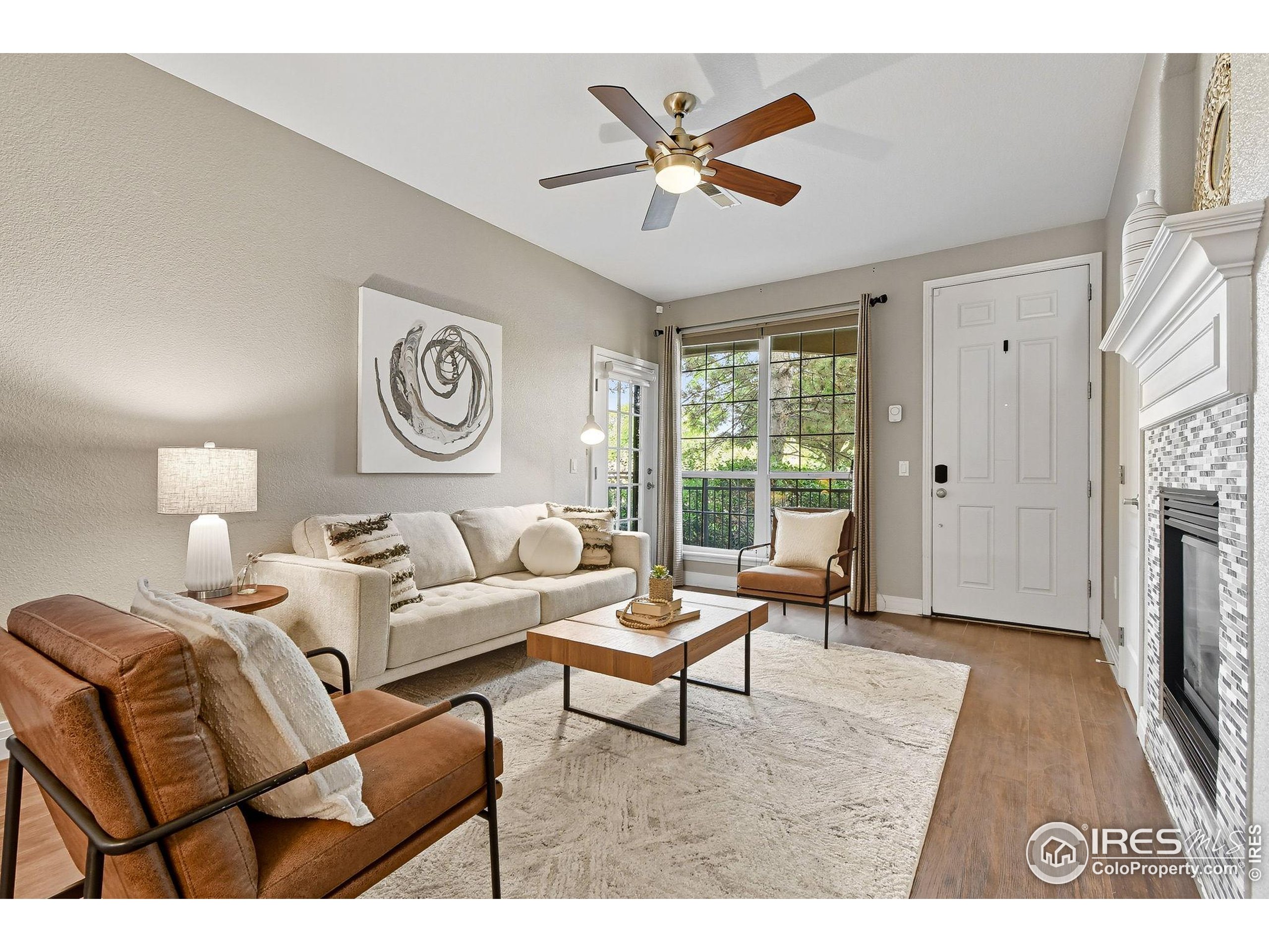 159 Quebec Street, Unit D Denver, CO 80220 - Photo 11 of 49 a living room with furniture a window and a ceiling fan