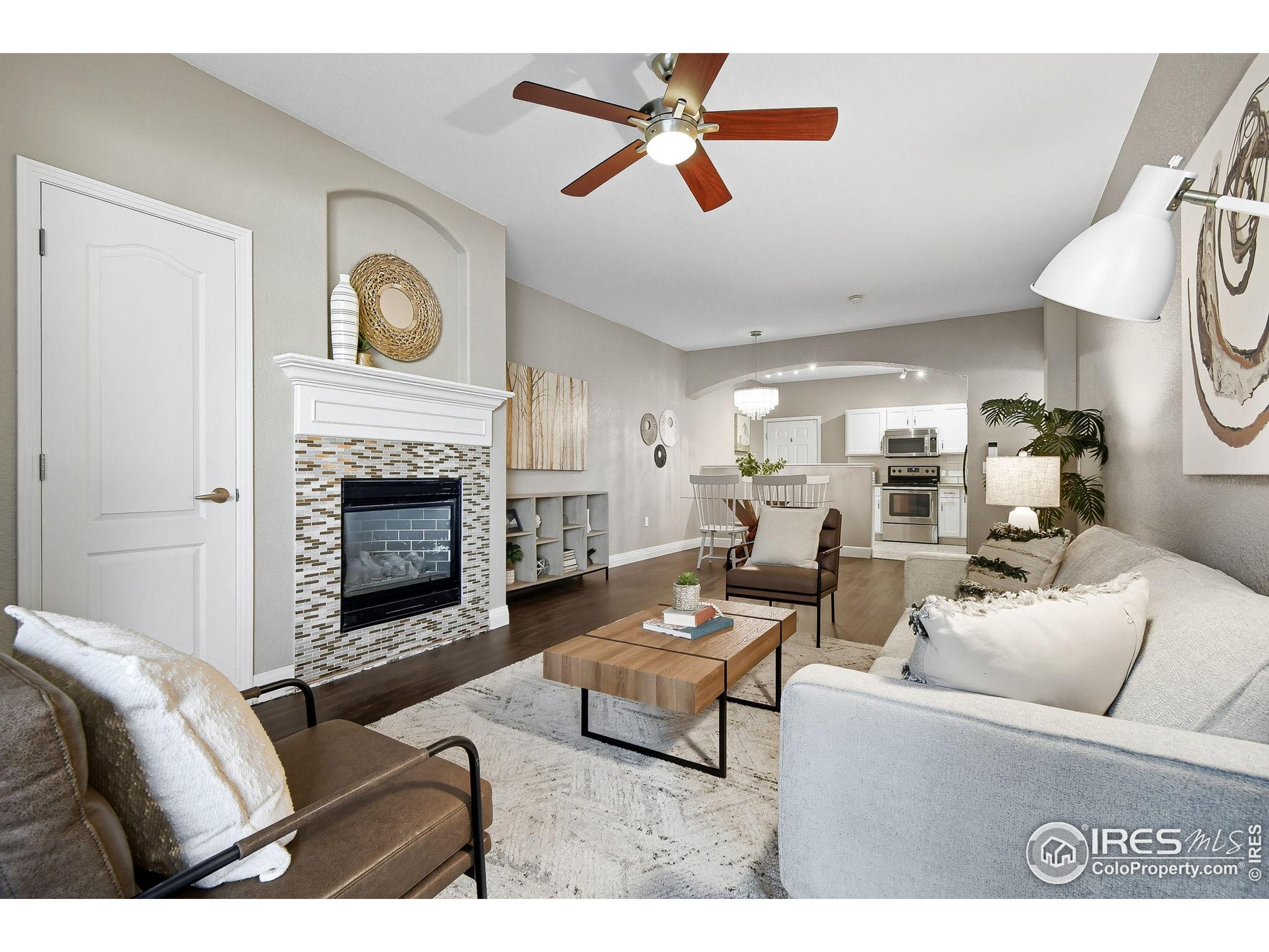 159 Quebec Street, Unit D Denver, CO 80220 - Photo 13 of 49 a living room with furniture a fireplace and a ceiling fan