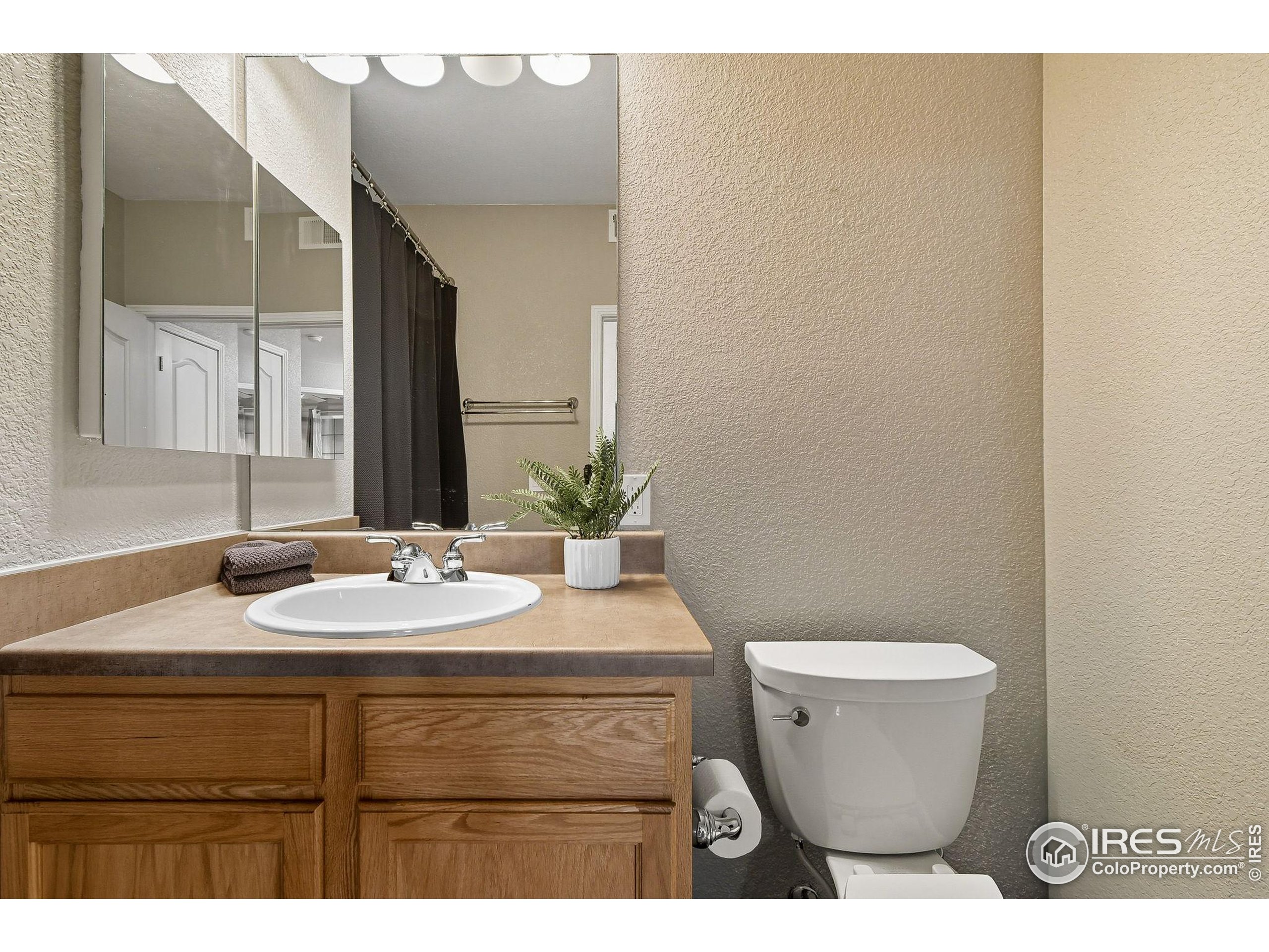 159 Quebec Street, Unit D Denver, CO 80220 - Photo 26 of 49 a bathroom with a sink and a mirror