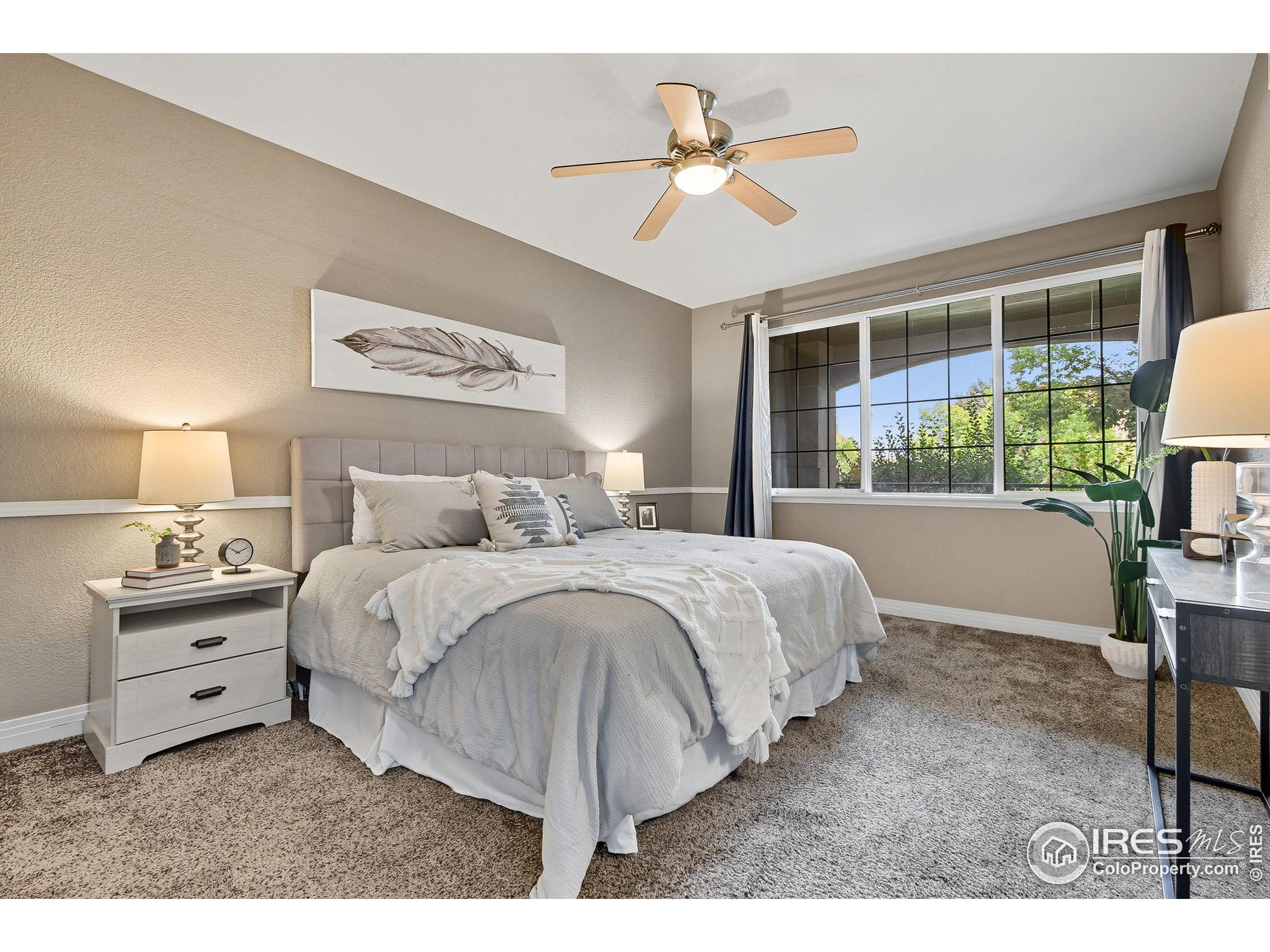 159 Quebec Street, Unit D Denver, CO 80220 - Photo 32 of 49 a bedroom with a bed and a chandelier