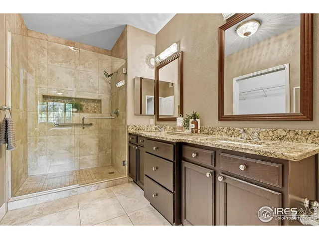 a bathroom with a granite countertop sink mirror and