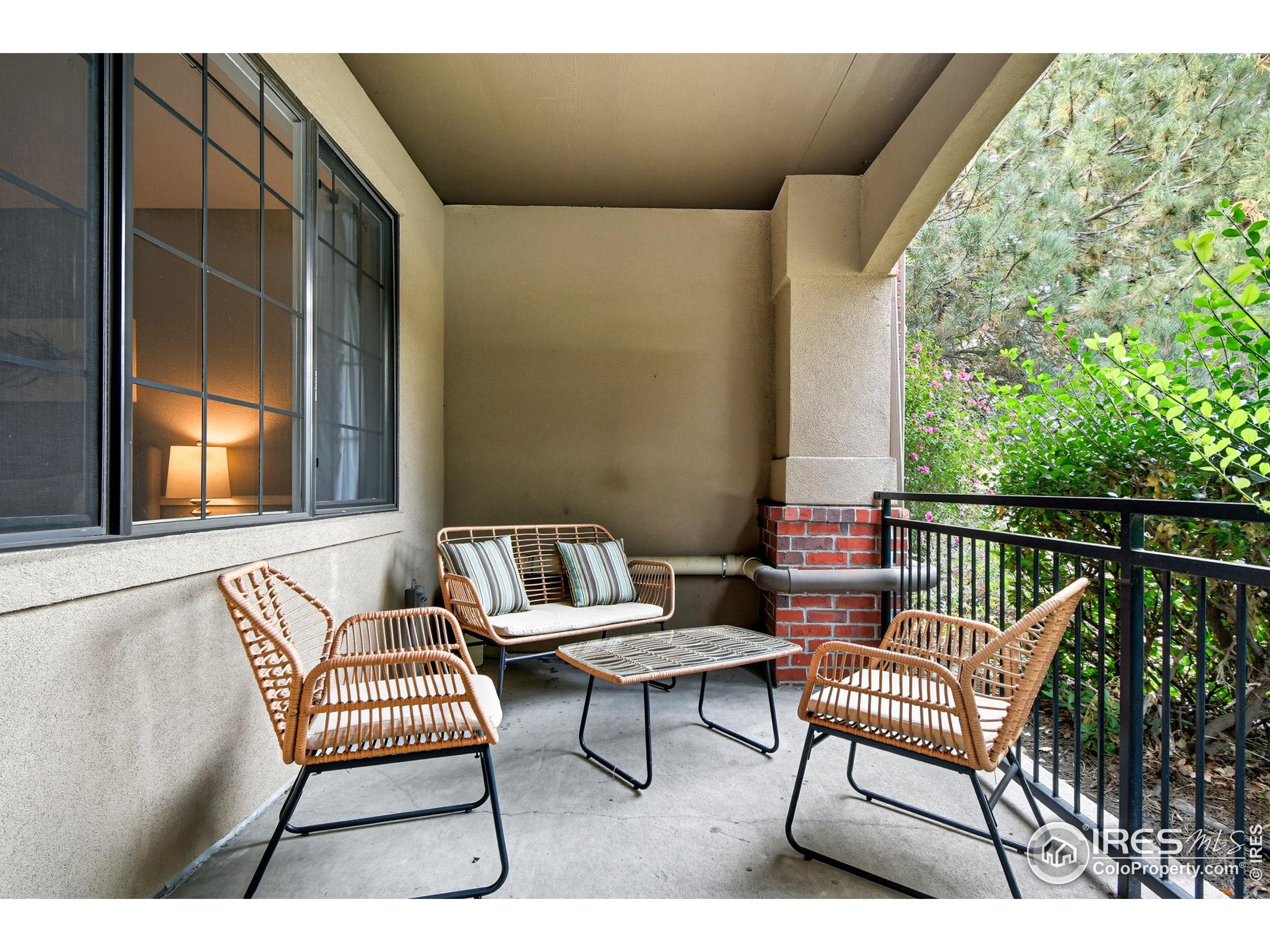 159 Quebec Street, Unit D Denver, CO 80220 - Photo 5 of 49 a balcony with wooden benches and a couch