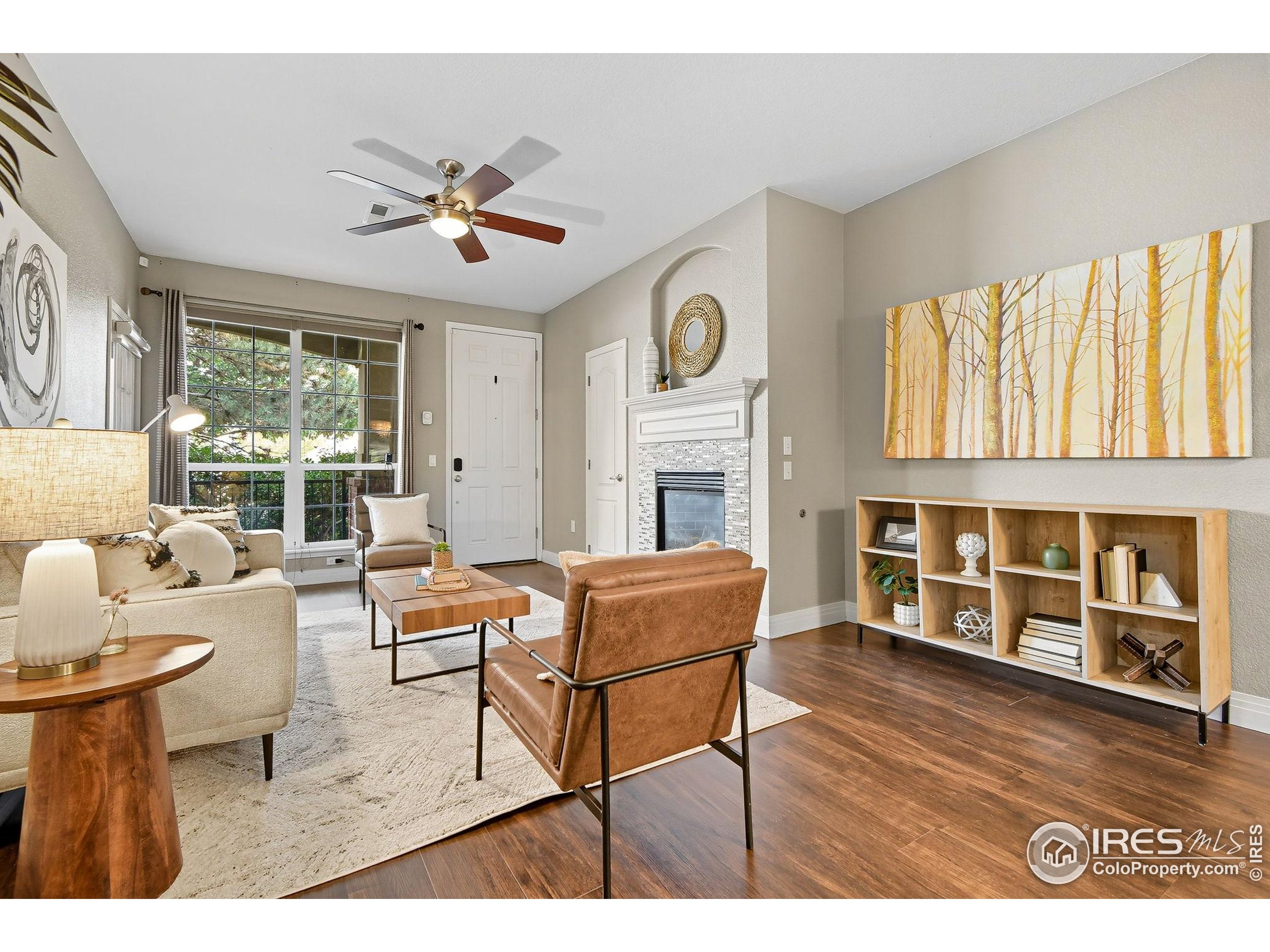 159 Quebec Street, Unit D Denver, CO 80220 - Photo 9 of 49 a living room with fireplace furniture and a large window