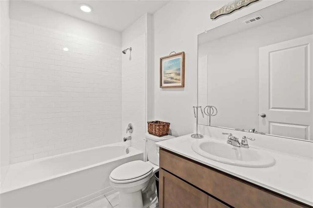 171 Seabiscuit Road Caddo Mills, TX 75135 - Photo 15 of 19 a bathroom with a granite countertop sink a toilet and a bathtub