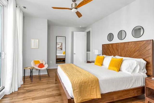 a bedroom with a bed and painting on the wall