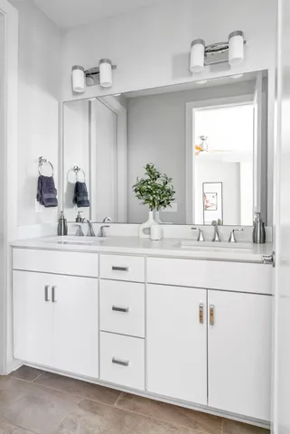 a bathroom with a sink vanity and mirror