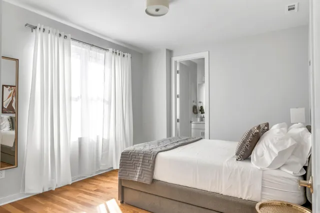 a bedroom with a bed and a window