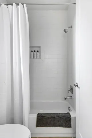 a bathroom with a tub and toilet