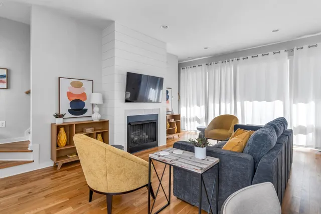 a living room with furniture a fireplace and a flat screen tv