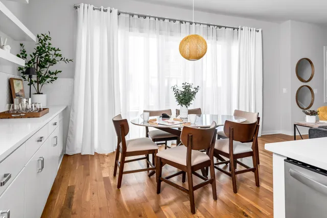 a dining room with wooden floor and breakfast area