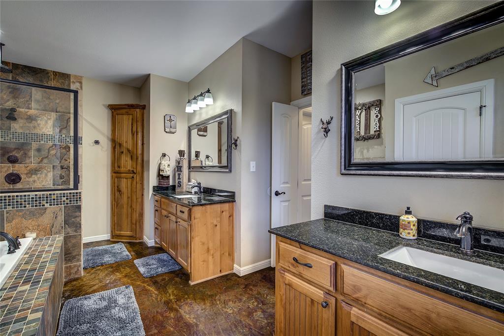 811 County Road 4250 Point, TX 75472 - Photo 20 of 37 En suite bathroom measuring 17’6” x 12’2”, featuring dual vanities, a garden tub, linen closet, separate custom shower with rainfall showerhead, and his-and-hers walk-in closets.