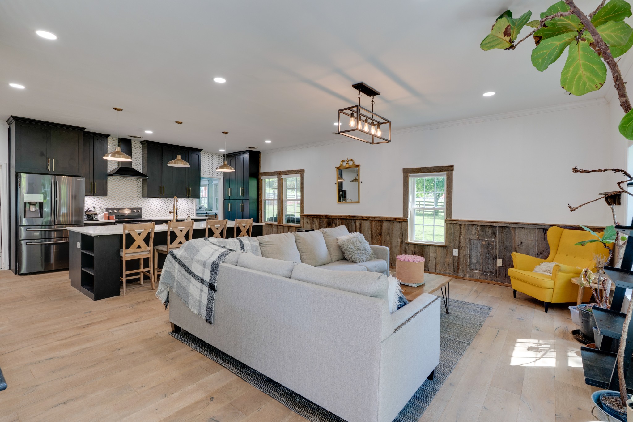 1199 Willis Branch Road Goodlettsville, TN 37072 - Photo 42 of 95 a living room with kitchen island furniture and a chandelier