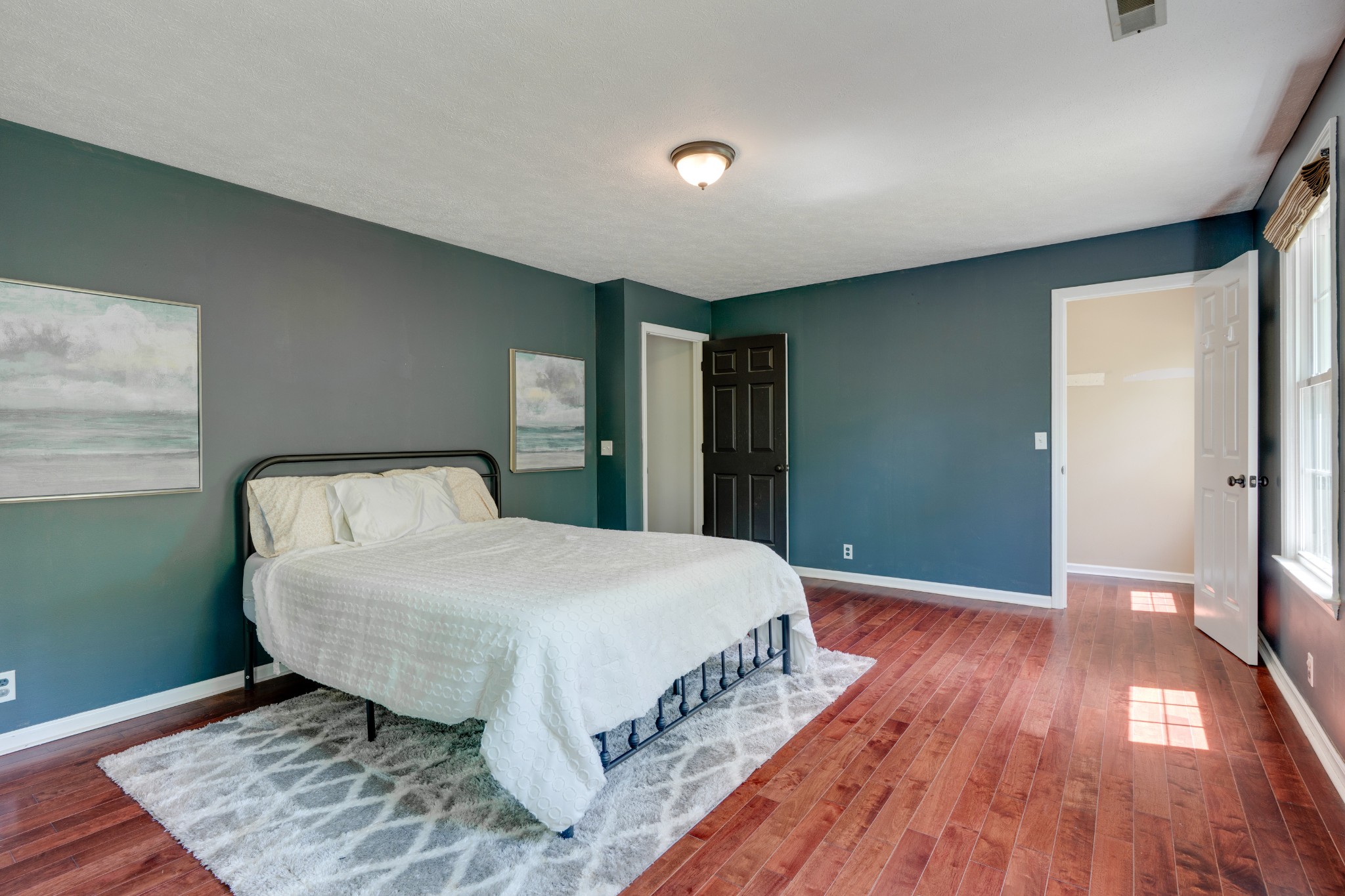 1199 Willis Branch Road Goodlettsville, TN 37072 - Photo 78 of 95 a spacious bedroom with a bed and wooden floor