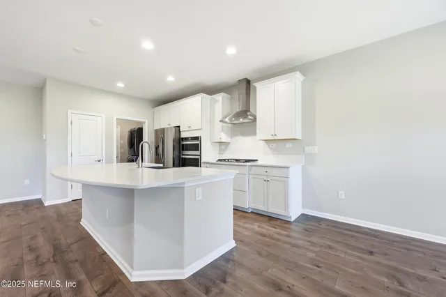 a view of kitchen with kitchen island sink and center island