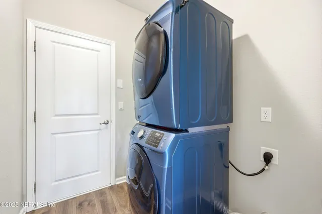 an empty room with sliding door and wooden door