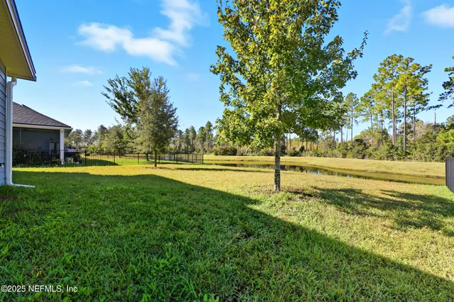 a view of a lake with houses in the back
