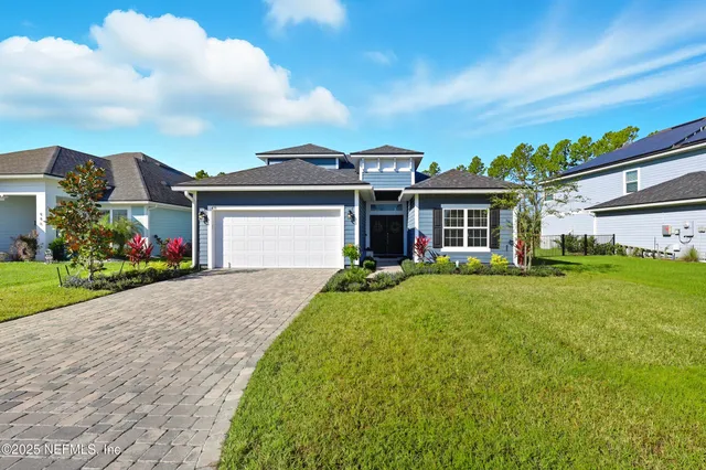 an aerial view of multiple houses with yard