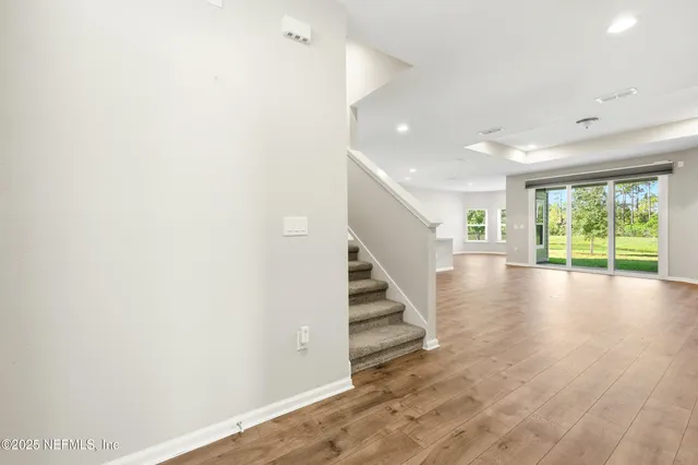 a view of an entryway with wooden floor