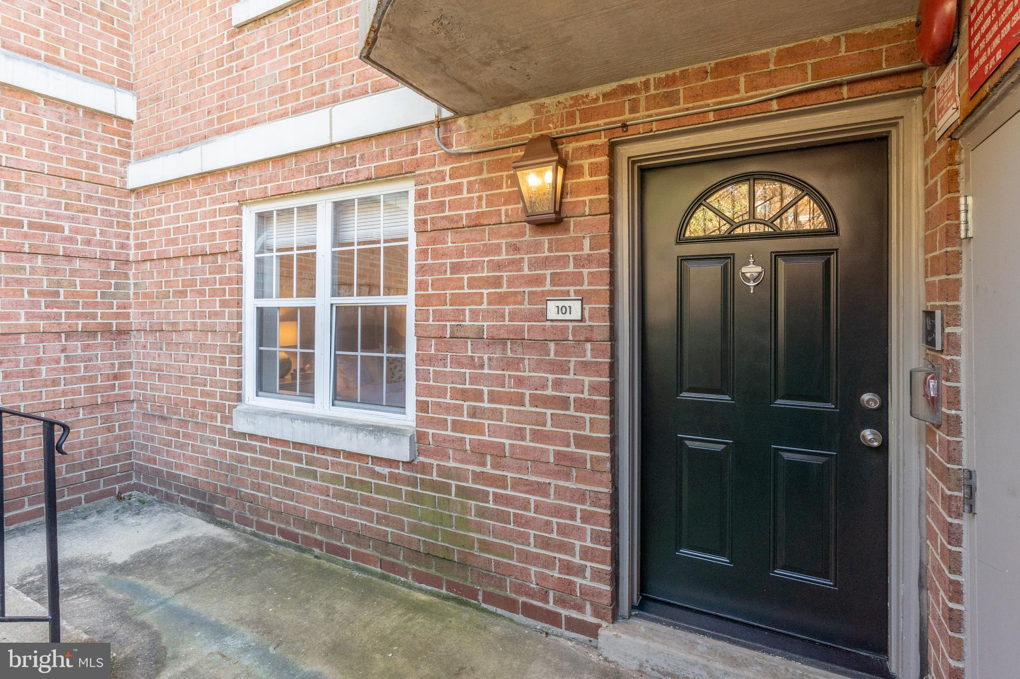 3806 Porter Street Northwest, Unit 101 Washington, DC 20016 - Photo 2 of 31 a front view of a house with a glass door