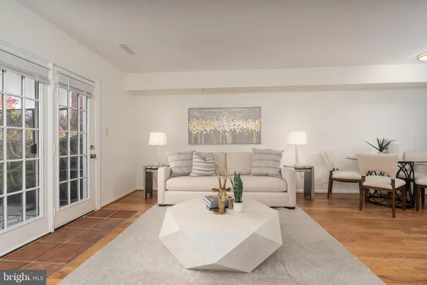 a living room with furniture lamp and a rug