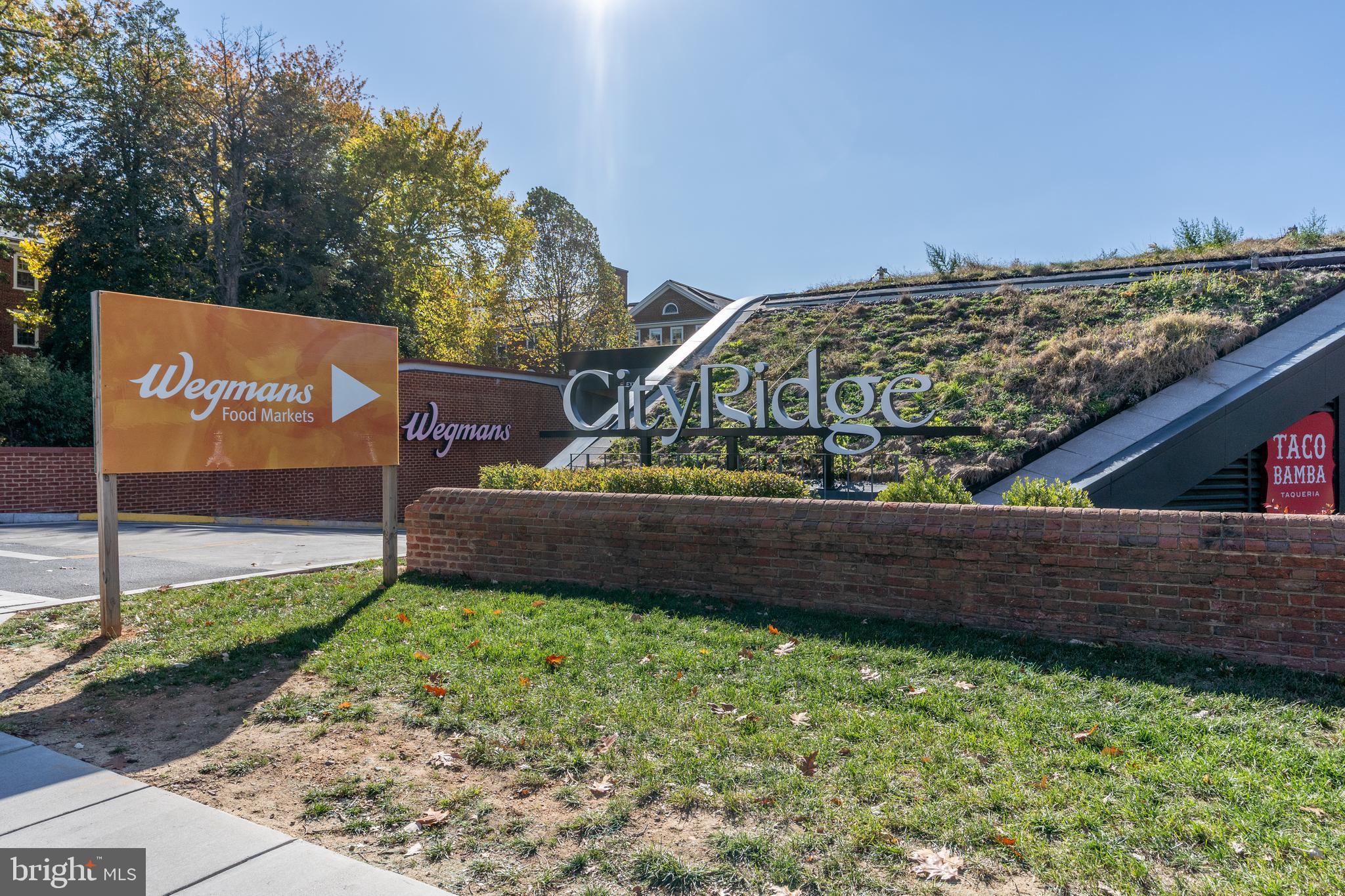 3806 Porter Street Northwest, Unit 101 Washington, DC 20016 - Photo 30 of 31 a view of a bench under an umbrella