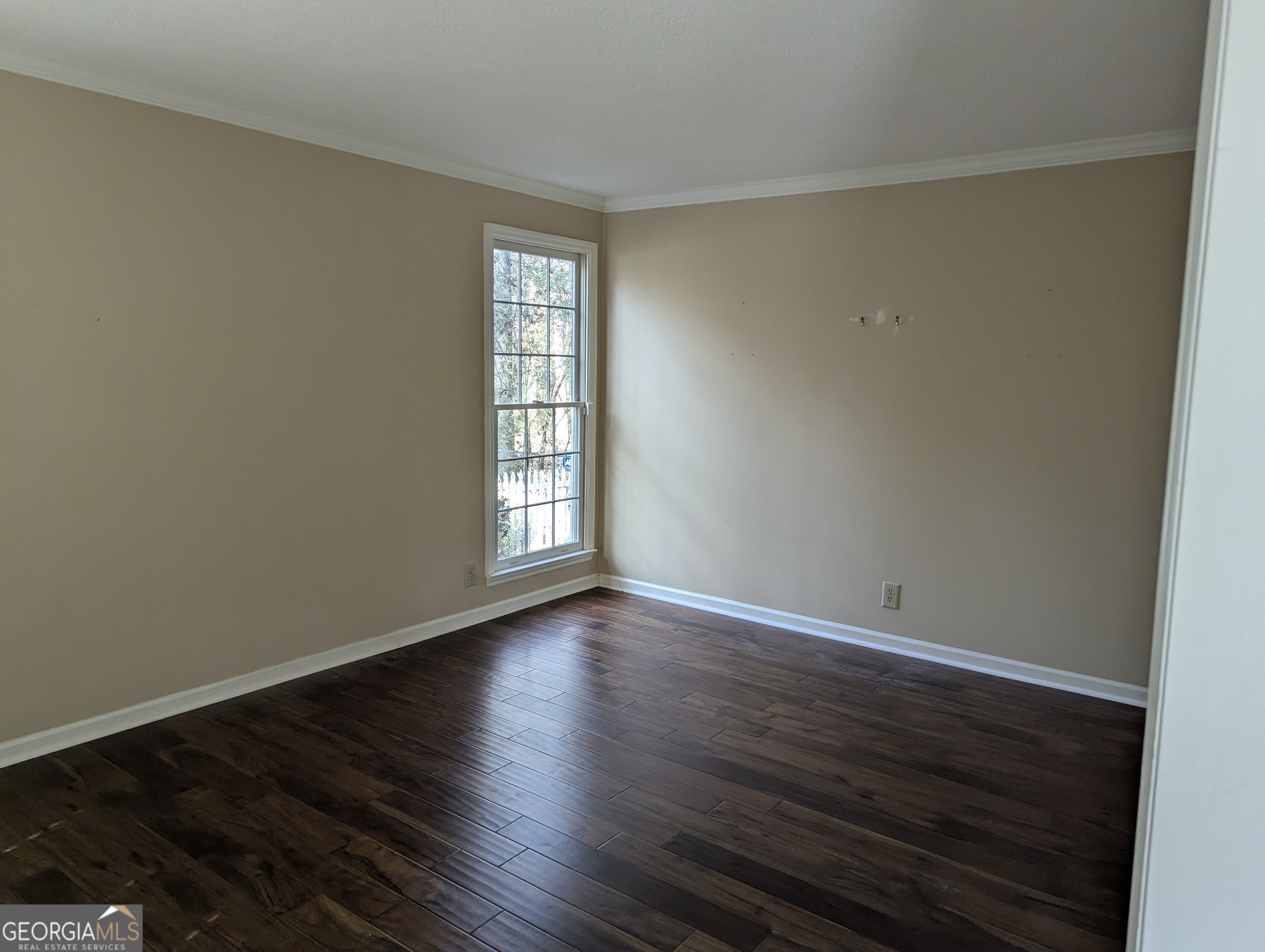 6111 Peake Road Macon, GA 31220 - Photo 7 of 21 a view of an empty room with wooden floor and a window