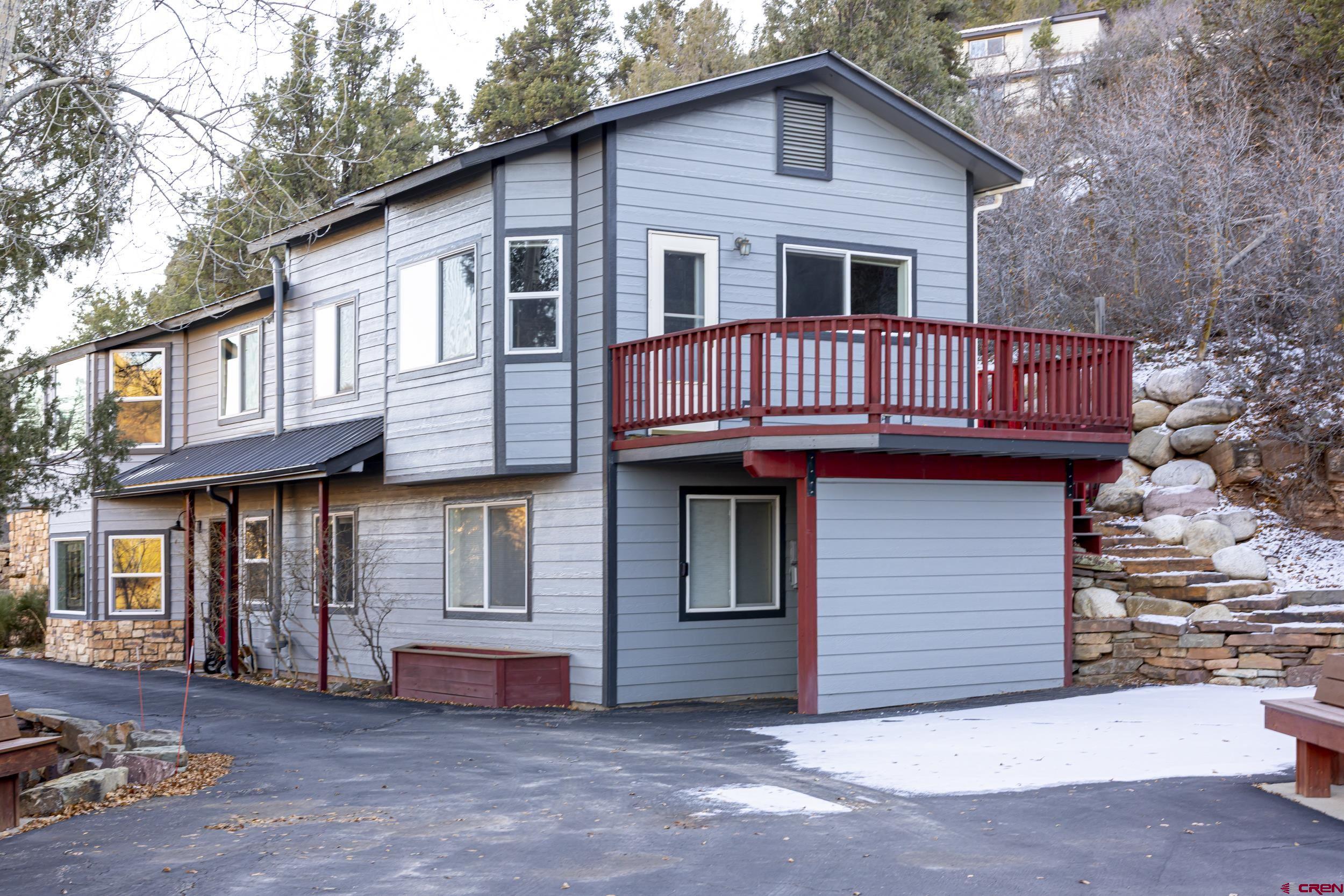 198 Spring Creek Drive Durango, CO 81301 - Photo 2 of 39 a view of a house with large windows and a small yard