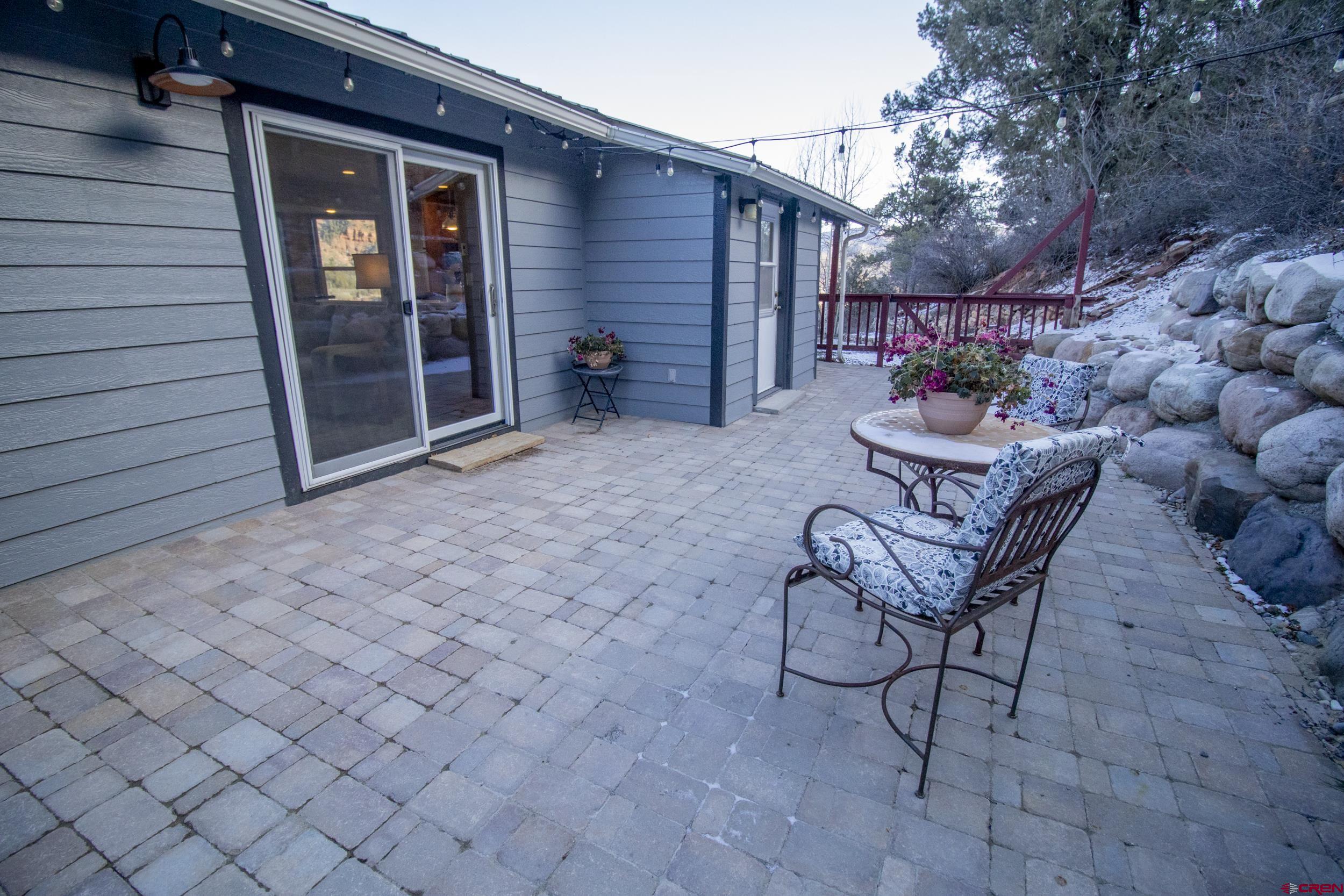 198 Spring Creek Drive Durango, CO 81301 - Photo 23 of 39 a backyard of a house with barbeque oven table and chairs