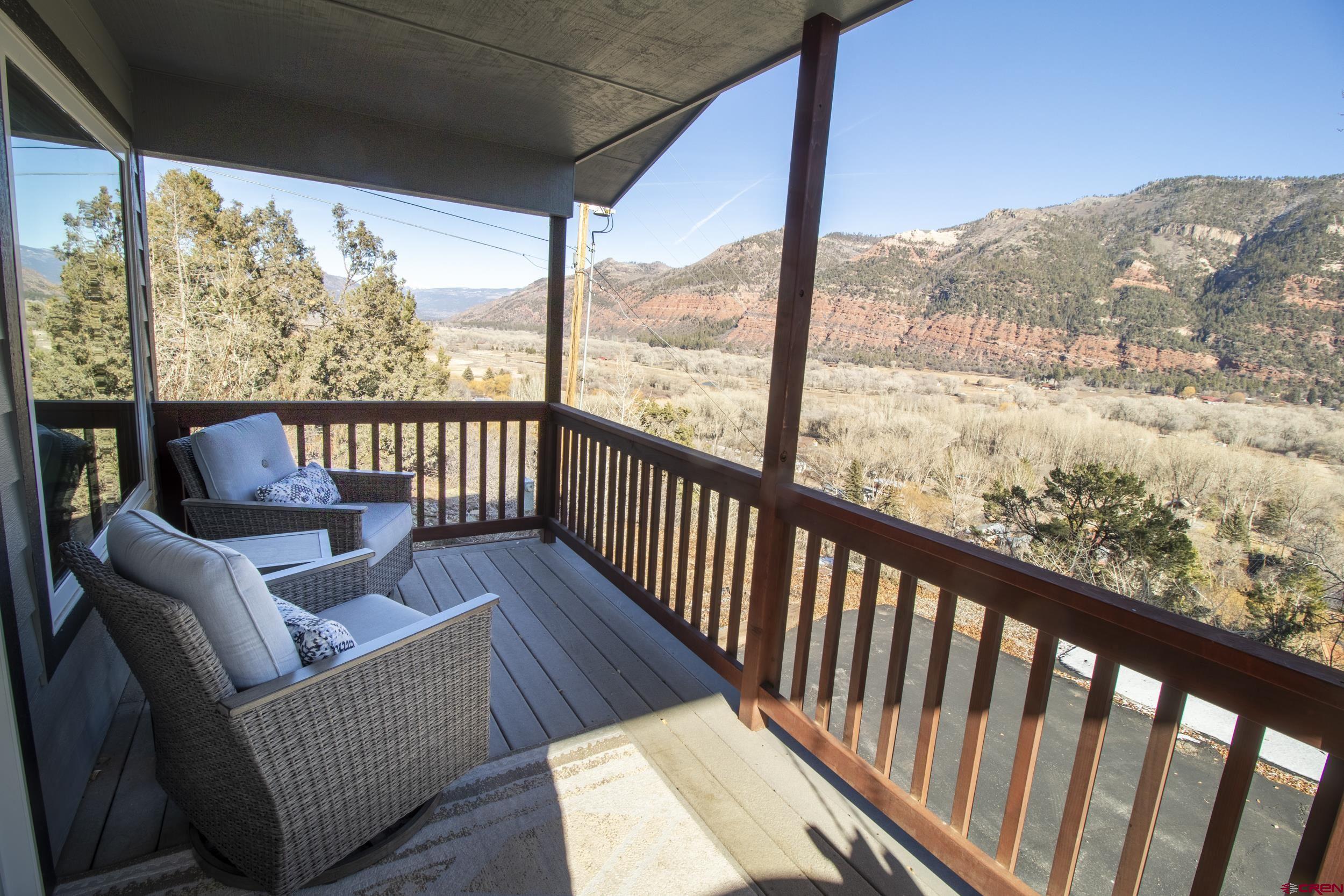 198 Spring Creek Drive Durango, CO 81301 - Photo 33 of 39 a view of a balcony with couches and wooden floor