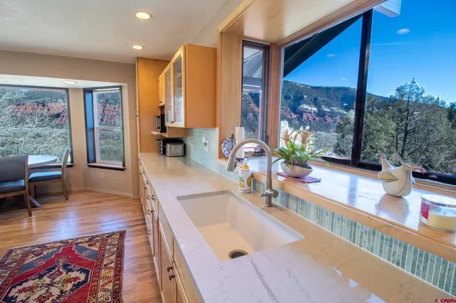 a view of a chairs and table in backyard