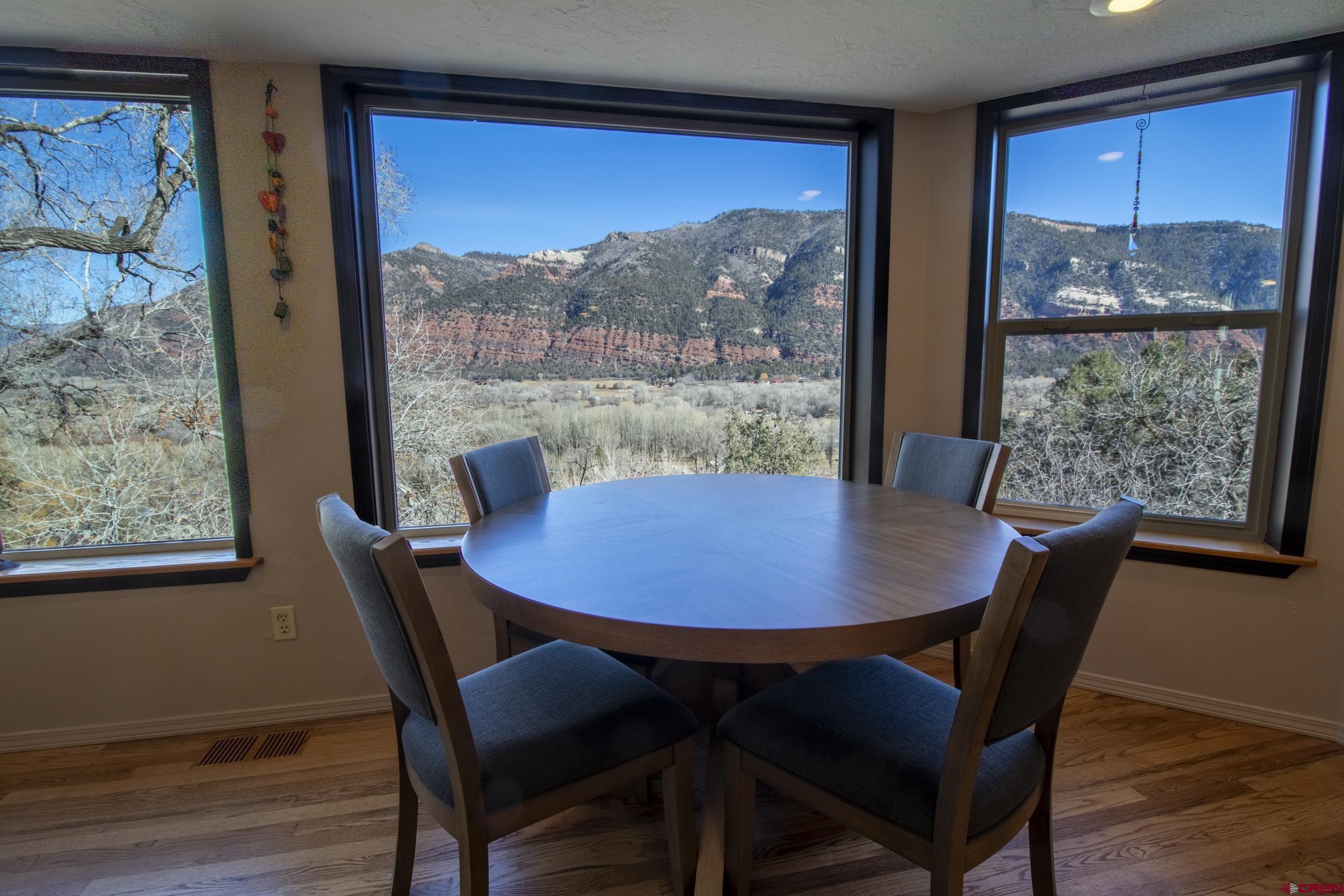 198 Spring Creek Drive Durango, CO 81301 - Photo 9 of 39 a view of a dining room with furniture window and wooden floor