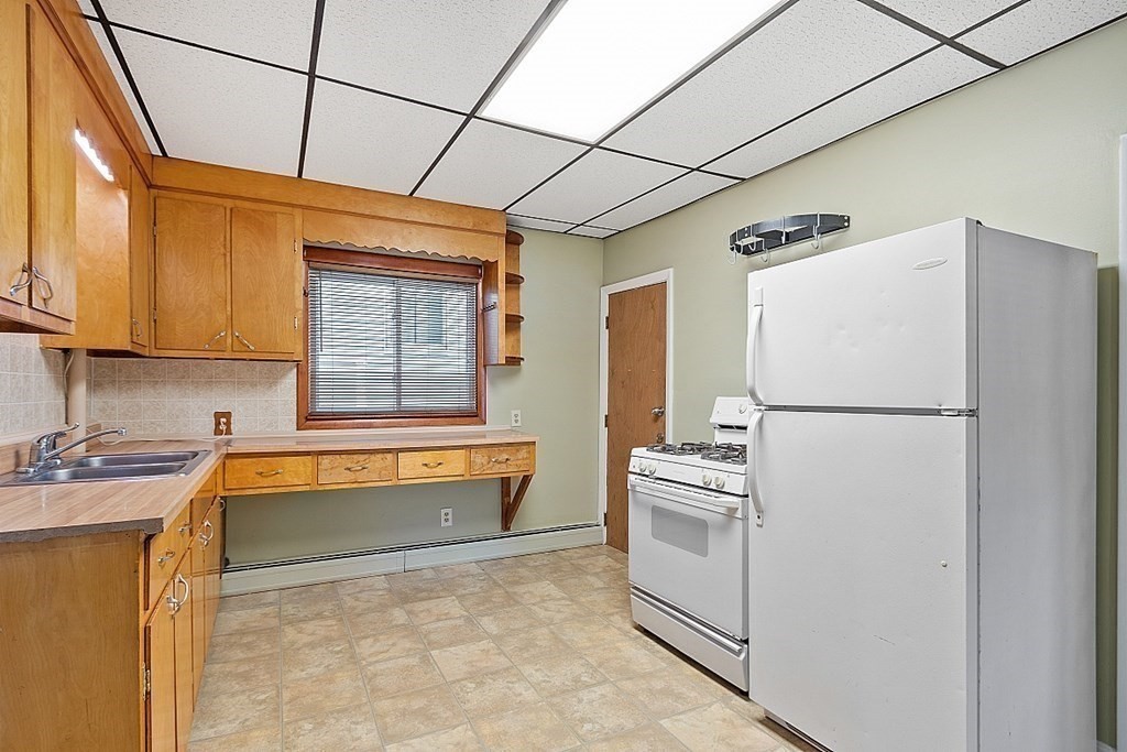 11 Autumn Street Lowell, MA 01852 - Photo 13 of 35 a kitchen with a refrigerator and a sink