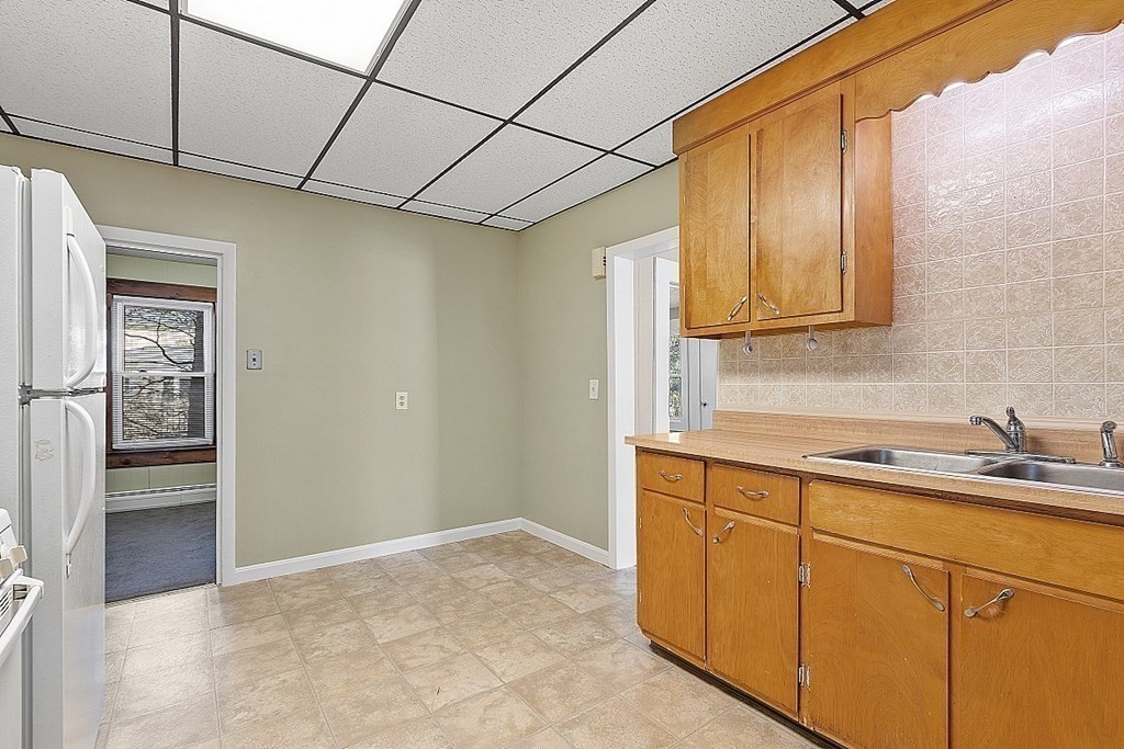 11 Autumn Street Lowell, MA 01852 - Photo 15 of 35 a kitchen with cabinets a sink and appliances