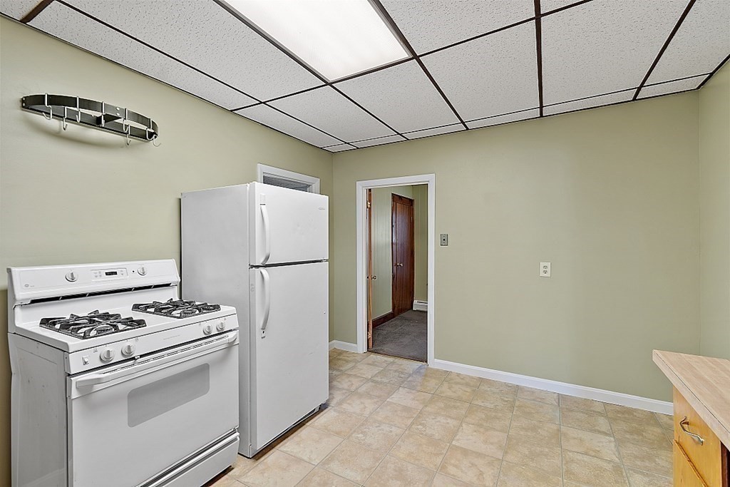 11 Autumn Street Lowell, MA 01852 - Photo 16 of 35 a kitchen with stainless steel appliances a refrigerator and a stove