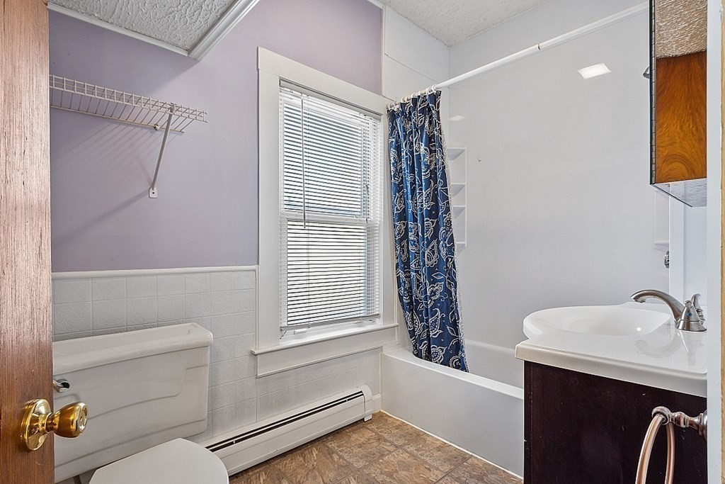 11 Autumn Street Lowell, MA 01852 - Photo 19 of 35 a bathroom with a sink a toilet and shower