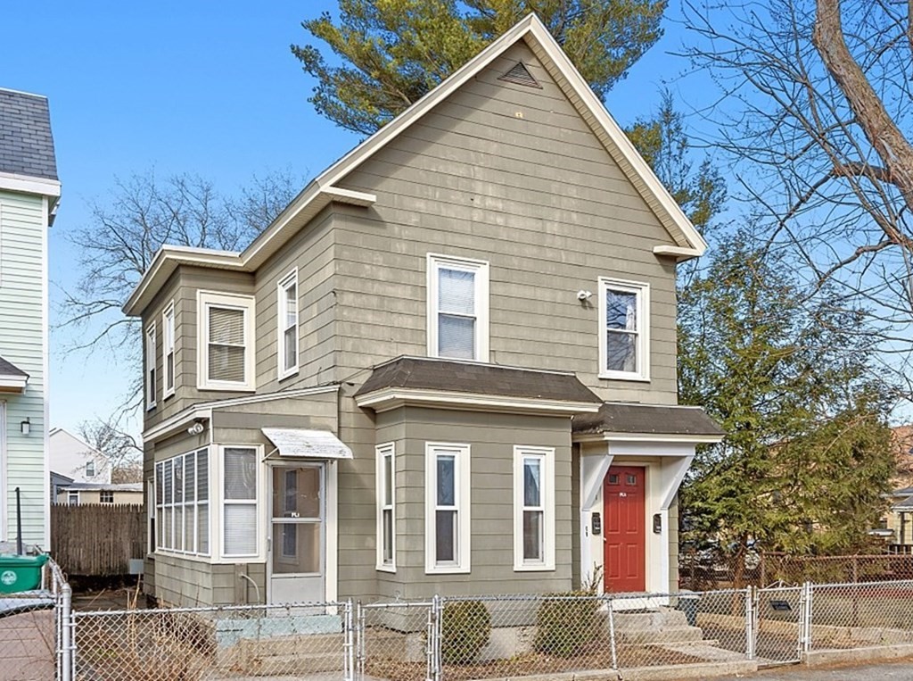 11 Autumn Street Lowell, MA 01852 - Photo 2 of 35 a front view of a house with a yard